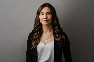 Dr. Angela Carter, Canada Research Chair in Equitable Energy Governance and Public Policy, is seen wearing a white shirt and dark coloured sweater